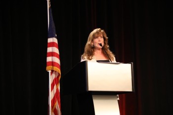At podium.