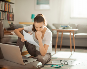 Woman sitting on floor working on laptop