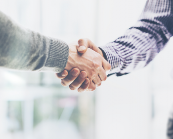 Close-up of two men shaking hands