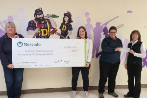 norvado employees present check to drummond school district