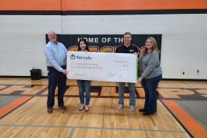 norvado employees present check to phillips school district